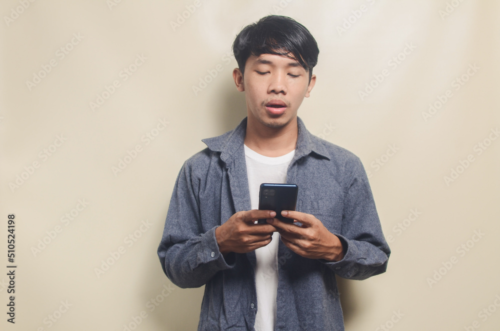 Portrait of handsome man in gray shirt sad on the phone Portrait of handsome man in gray shirt sad on the phone