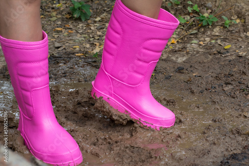 Farmer boot shoes  and equipment in the wet  soil  when after raining