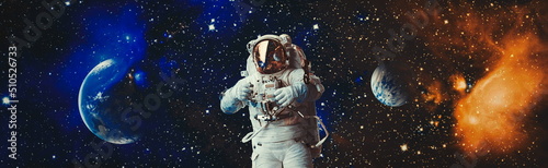 Obraz na płótnie Picture of astronaut spacewalking with glowing stars