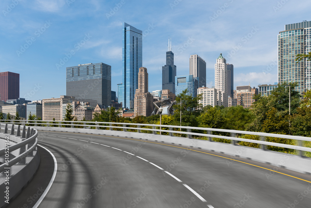 Empty urban asphalt road exterior with city buildings background. New modern highway concrete construction. Concept of way to success. Transportation logistic industry fast delivery. Chicago. USA. Empty urban asphalt road exterior with city buildings background. New modern highway concrete construction. Concept of way to success. Transportation logistic industry fast delivery. Chicago. USA.