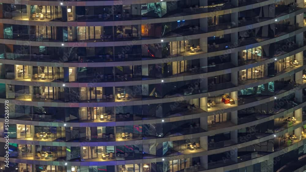 Outside view of windows in apartments of a high class building at night timelapse. Glowing lights in skyscraper with balconies Outside view of windows in apartments of a high class building at night timelapse. Glowing lights in skyscraper with balconies