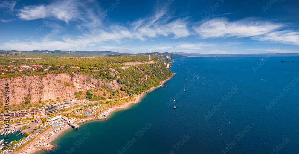 Panoramic summer view from flying drone of Marina di Portopiccolo town,Trieste location, Italy, Europe. Aerial morning scene of Portopiccolo Sistiana Beach. Vacation concept background.