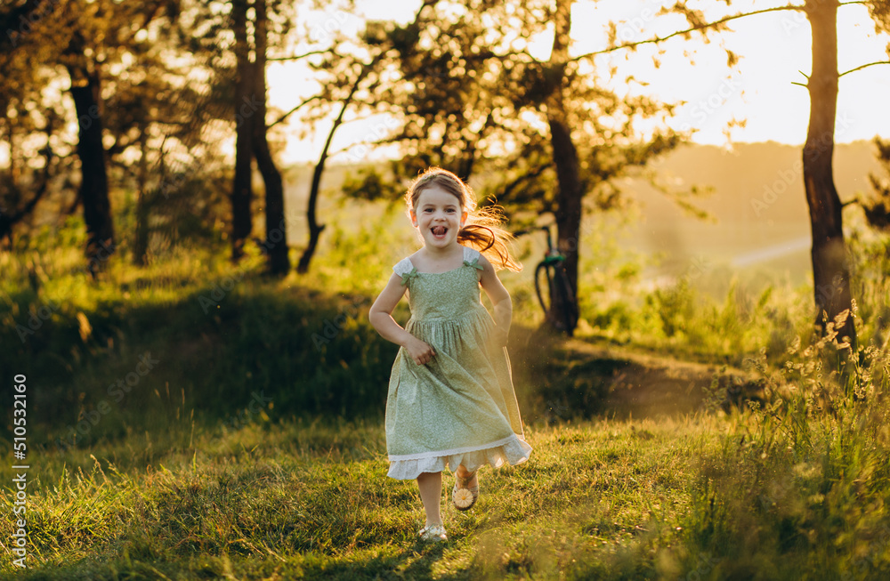 happy baby smiling. little girl running at sunset happy baby smiling. little girl running at sunset