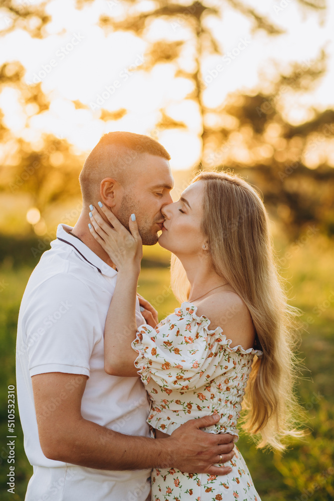 beautiful shot of kissing couple in the sunlight
