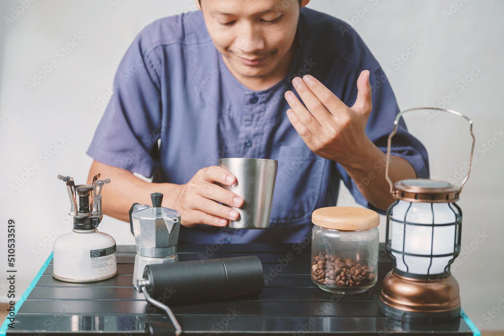 Asian boy learning to make coffee with moka pot. Asian boy learning to make coffee with moka pot.