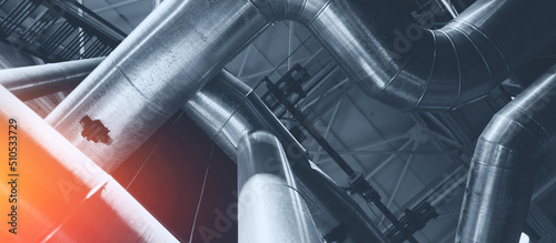 Industrial concept background blue toning. Steel pipelines, valves gas and oil refinery plant industry with sunlight