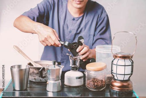Asian boy learning to make coffee with moka pot.
