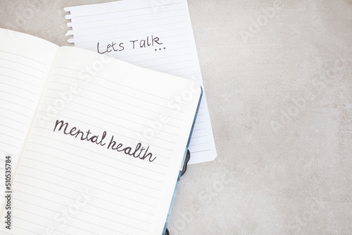 let’s talk mental health. Handwritten on notebook with grunge or rustic background and copy space 