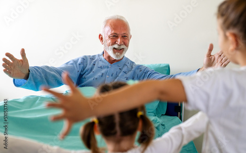 Little girls visiting grandfather in hospital, who is recovering from coronavirus.