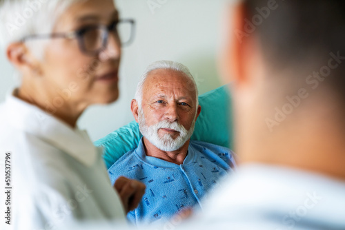 Doctors consulting a senior man patient in hospital. Healthcare people insurance concept