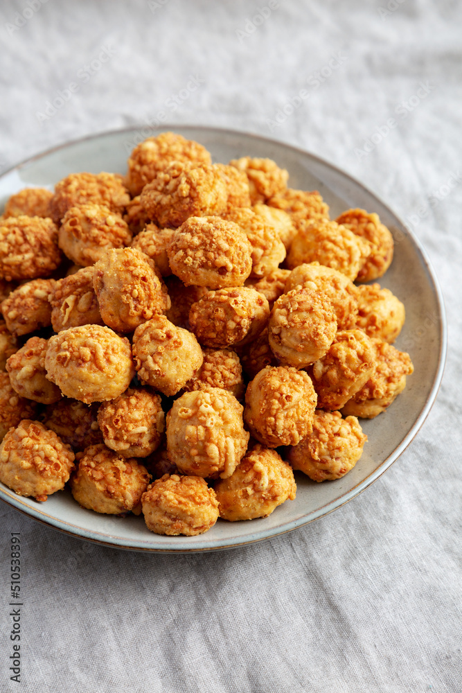 Homemade Crumbly Biscuits with Parmigiano Reggiano on a Plate, low angle view. Homemade Crumbly Biscuits with Parmigiano Reggiano on a Plate, low angle view.
