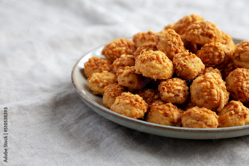 Homemade Crumbly Biscuits with Parmigiano Reggiano on a Plate, side view. Copy space. Homemade Crumbly Biscuits with Parmigiano Reggiano on a Plate, side view. Copy space.