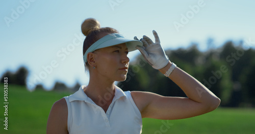 Attractive golfer look game match at course. Woman check result on summer field.