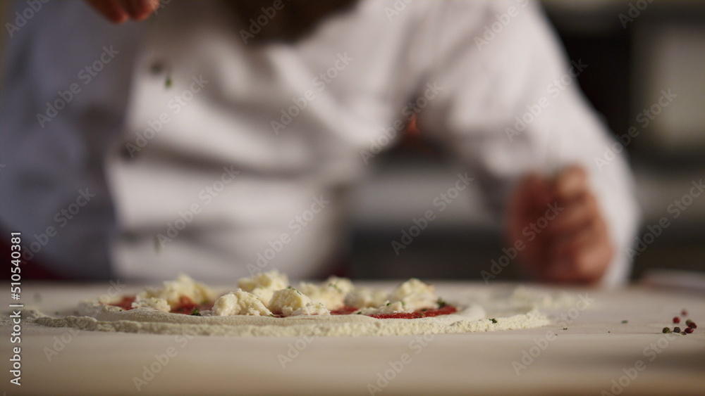 Chef cooking italian pizza in restaurant. Pastry cook preparing traditional food