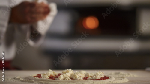 Pastry cook making pizza pepperoni in restaurant kitchen. Cooking food concept.
