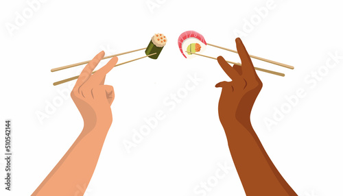 hands raised t hold in chopsticks rolls and sushi