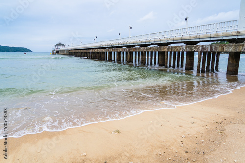 Side view of pier at the beach at sunset time.Thailand. © bubbers