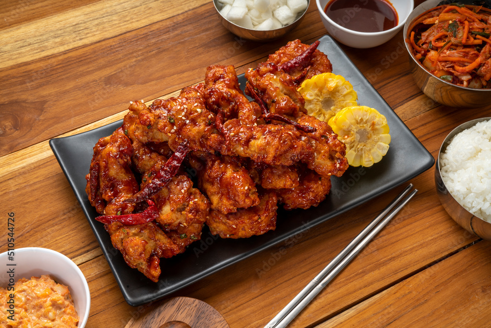 Fried chicken with spicy sauce traditional Korean food, Fried chicken with sweetcorn and Kimchi pickle on wooden table. Fried chicken with spicy sauce traditional Korean food, Fried chicken with sweetcorn and Kimchi pickle on wooden table.