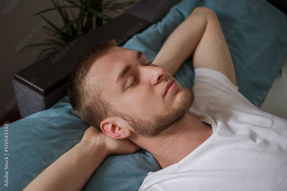 A man in pajamas sleeps A man in pajamas sleeps