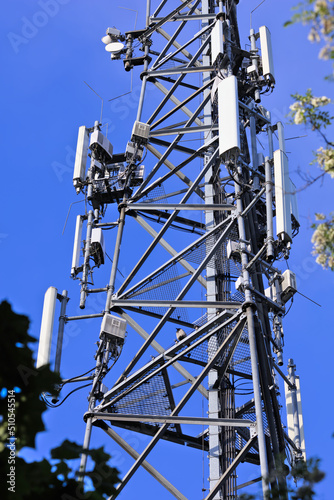 Mobile phone mast antenna, blue sky background photo