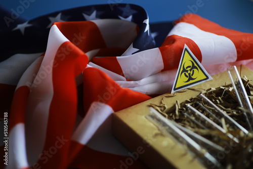 American flag and biohazard sign. The concept of American biolabs and research centers. photo