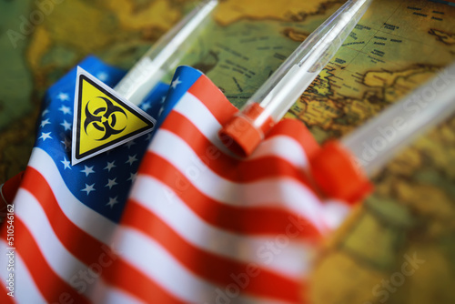 American flag and biohazard sign. The concept of American biolabs and research centers. photo