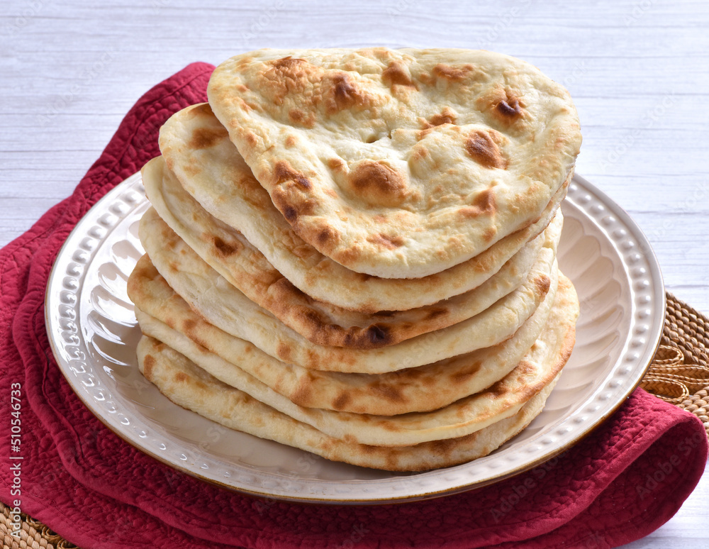 Tandoori Nan, A delicious and healthy wheat based flat bread, baked in clay oven. A famous bread of Pakistan, Afghanistan and Indian. Tandoori Nan, A delicious and healthy wheat based flat bread, baked in clay oven. A famous bread of Pakistan, Afghanistan and Indian.