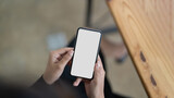 Woman using mobile phone, empty mockup screen for your own design. Above shot