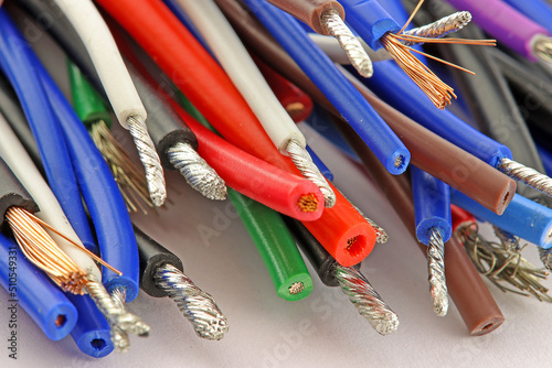 Colored copper wires on an electrical diagram in close-up. 