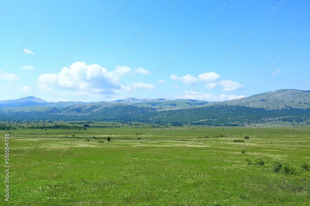 Mountain landscape with meadows and hills. Karst field in Lika region, Croatia.