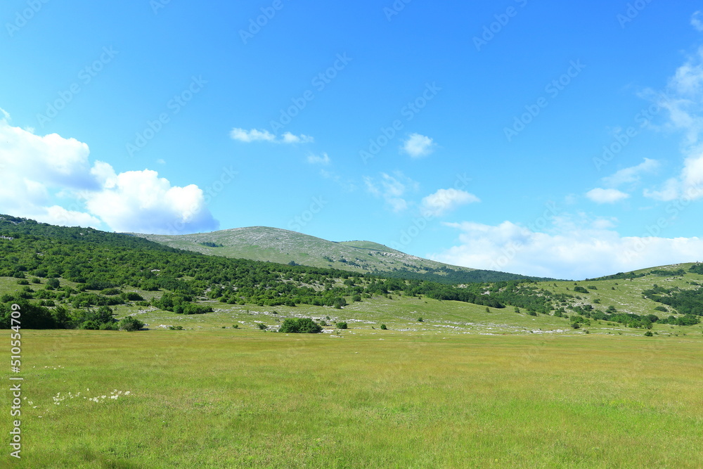 Mountain landscape with meadows and hills. Karst field in Lika region, Croatia. Mountain landscape with meadows and hills. Karst field in Lika region, Croatia.