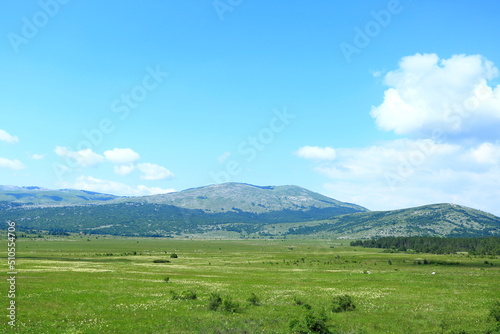 Mountain landscape with meadows and hills. Karst field in Lika region, Croatia. photo