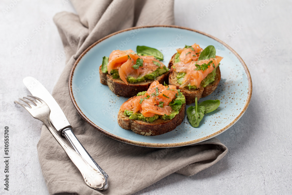 Salmon avocado keto sandwiches on healthy seed buns.