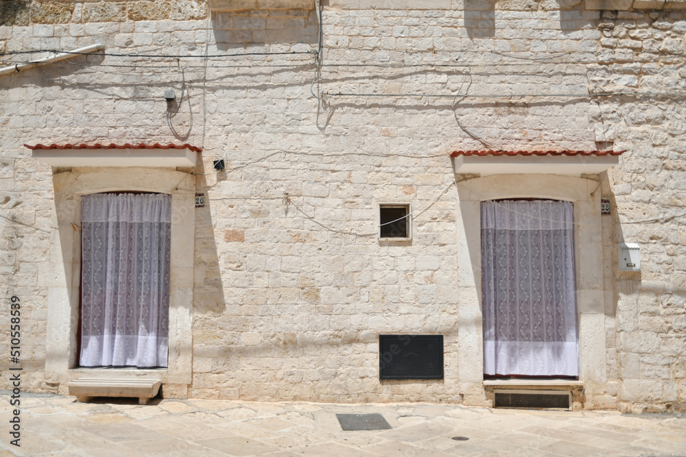 The facade of a house in a small street in Casamassima, a village with blue colored houses in the Puglia region, Italy.