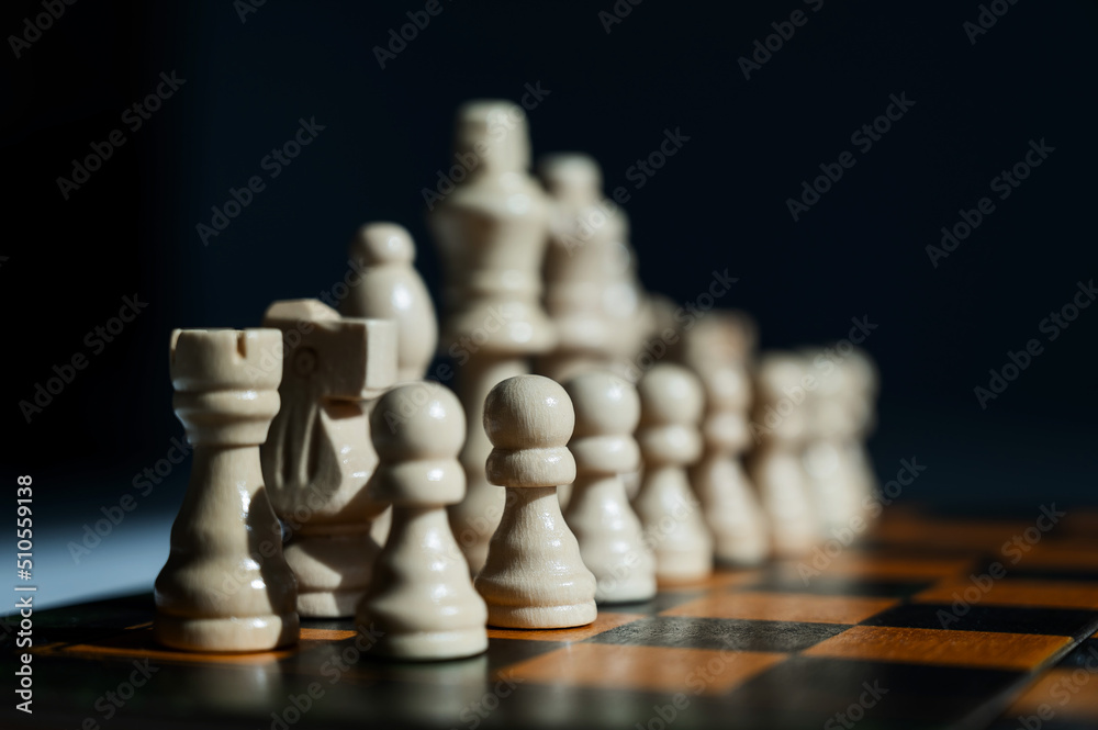Chessboard with pieces on a white table. Chessboard with pieces on a white table.