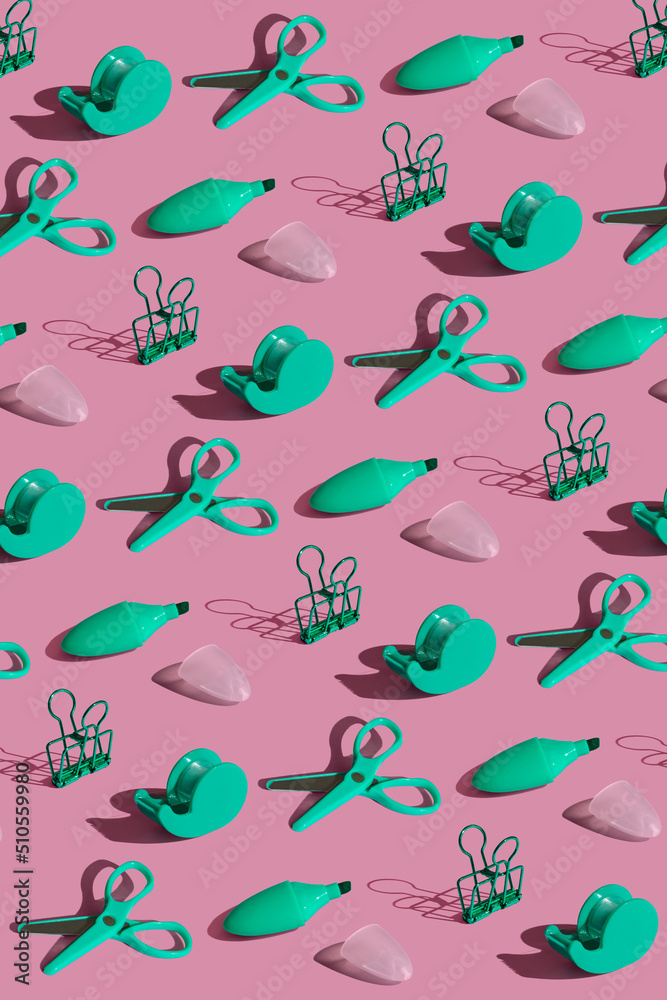 Flat lay pattern composition with school green stationery supplies on pink pastel background. Vivid color minimal overhead shot. Back to school concept. Top view with sharp shadows. Flat lay pattern composition with school green stationery supplies on pink pastel background. Vivid color minimal overhead shot. Back to school concept. Top view with sharp shadows.