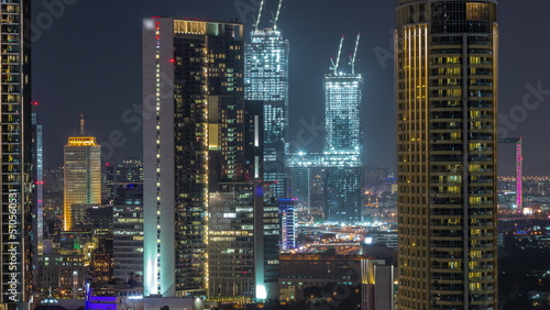 Aerial view of Dubai International Financial Centre district skyscrapers night timelapse