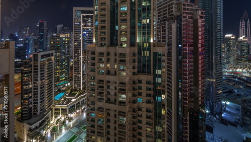 Aerial cityscape night timelapse with illuminated architecture of Dubai downtown.