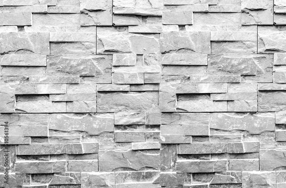 Obraz premium Pared blanca con textura de azulejos de piedra.