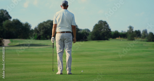 Man standing golf course alone outdoors. Sport player enjoy fresh air in summer.