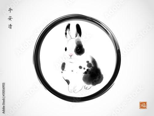 Ink painting of a rabbit in black enso zen circle. Traditional oriental ink painting sumi-e, u-sin, go-hua. Hieroglyphs - eternity, freedom, happiness, well-being