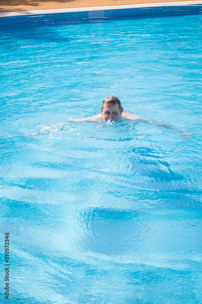custom made wallpaper toronto digitalAn elderly gray-haired retired man swims in the pool. The concept of a healthy active lifestyle in old age