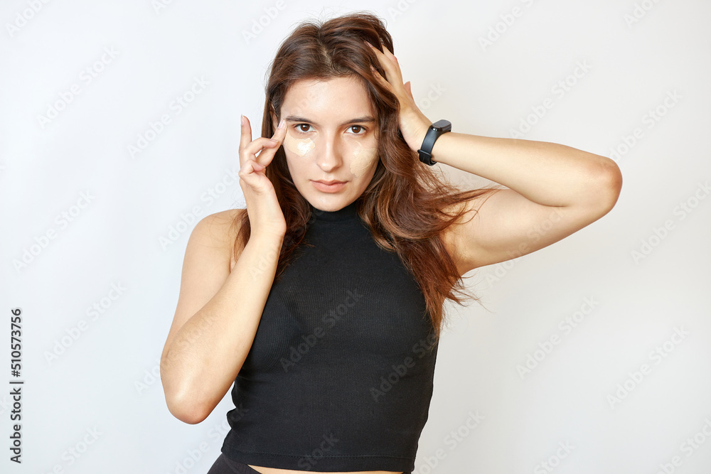 Beautiful girl applies foundation on her face. Beautiful girl applies foundation on her face.