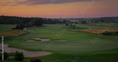 Aerial golf park sunset at cloud sky nature landscape. Golfing field background.