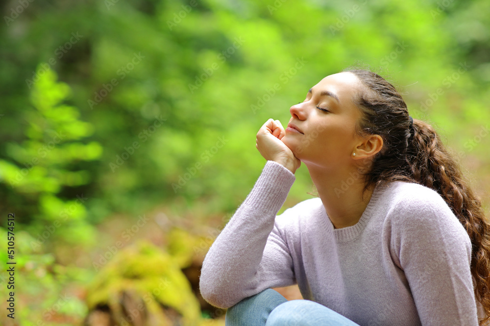 Relaxed woman in a beautiful green forest Relaxed woman in a beautiful green forest