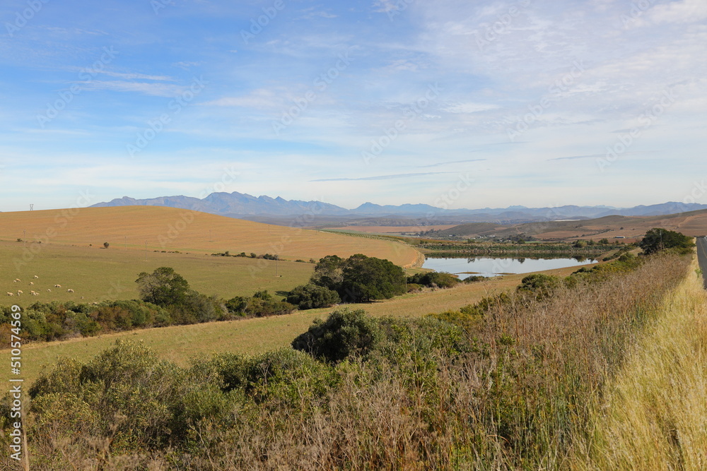 A view towards Ashton, South Africa, showing beautiful valleys and a dam.
