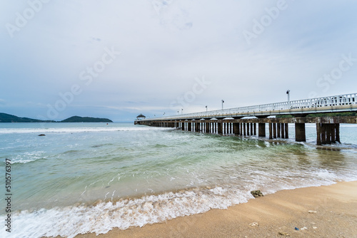 Side view of pier at the beach at sunset time.Thailand. © bubbers