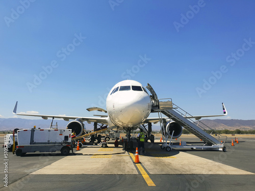 Loading luggages into an airliner on the tarmac. boarding an airplane on the airport runway