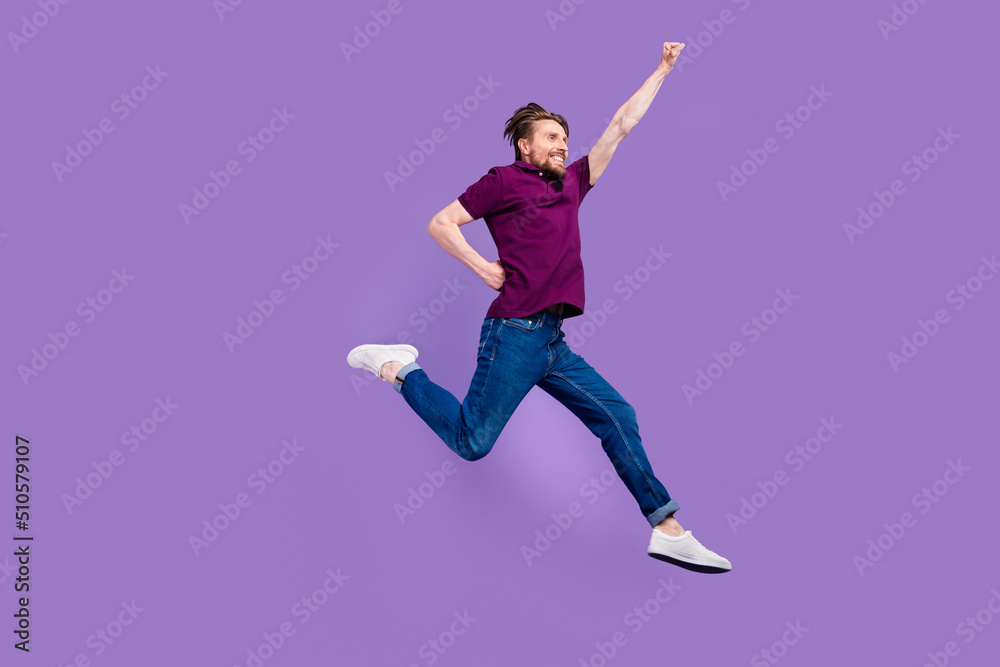 Full size profile side photo of young man go walk superhero jumper isolated over violet color background