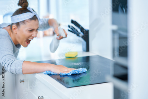 Young woman cleaning dirt in the kitchen